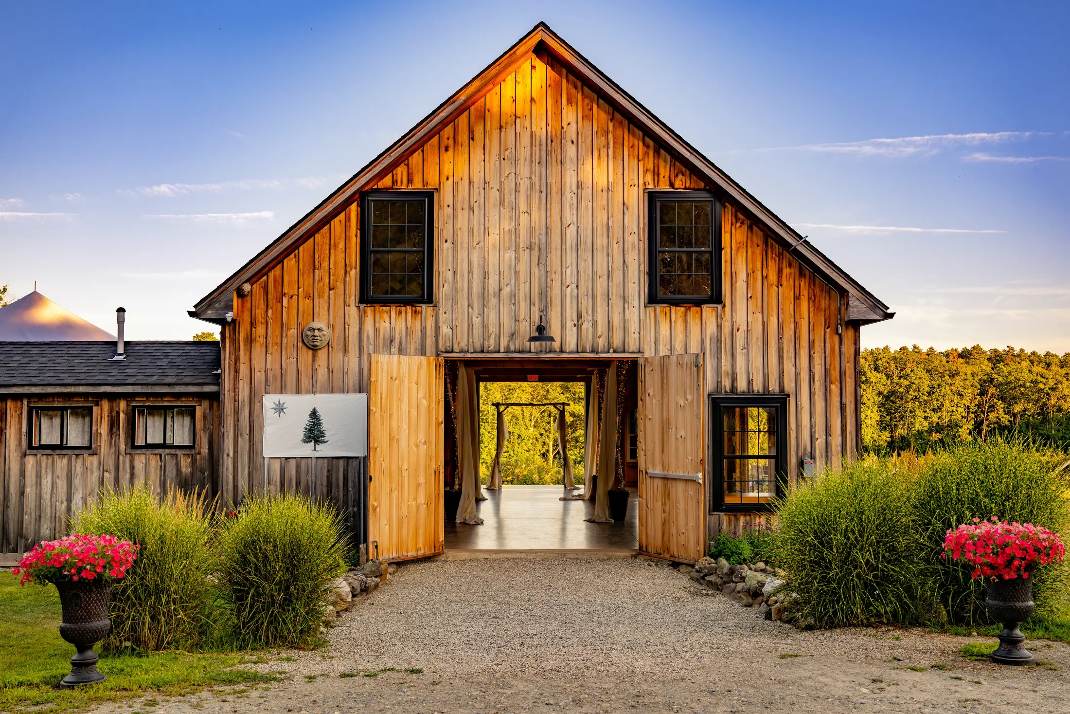 The barn at golden hour with sunflowers behind it